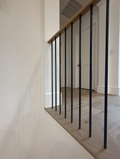 Modern White Oak Wood Over-Post Handrail and Round Iron Balusters
