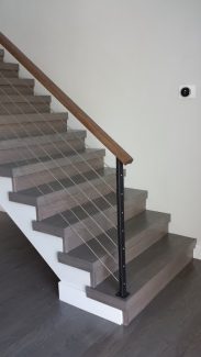 Steel Cables with Wooden Cap Rail On Free-Standing Staircase