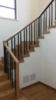 Glass Panels behind Iron Balusters with Wooden Cap Rail/Custom Wood Newel on open stringer