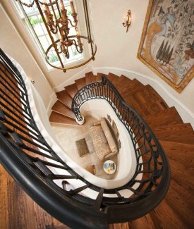 Full Oak Treads and Custom Forged Iron Railing On Bent Staircase