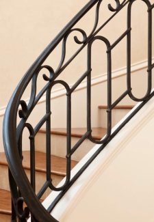 Full Oak Treads and Forged Iron Railing On Bent Staircase
