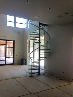 Glass Spiral Staircase With Open Risers and Steel Treads