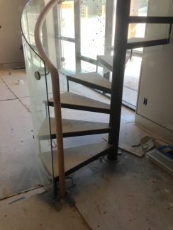 Glass Spiral Staircase With Open Risers and Steel Treads
