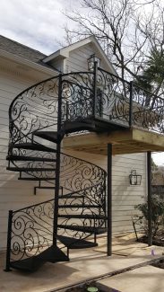 Exterior Spiral Staircase With Custom Forged Iron Panels
